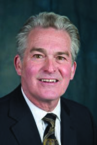 Grey haired white male named Gary Holquist facing the camera and smiling.